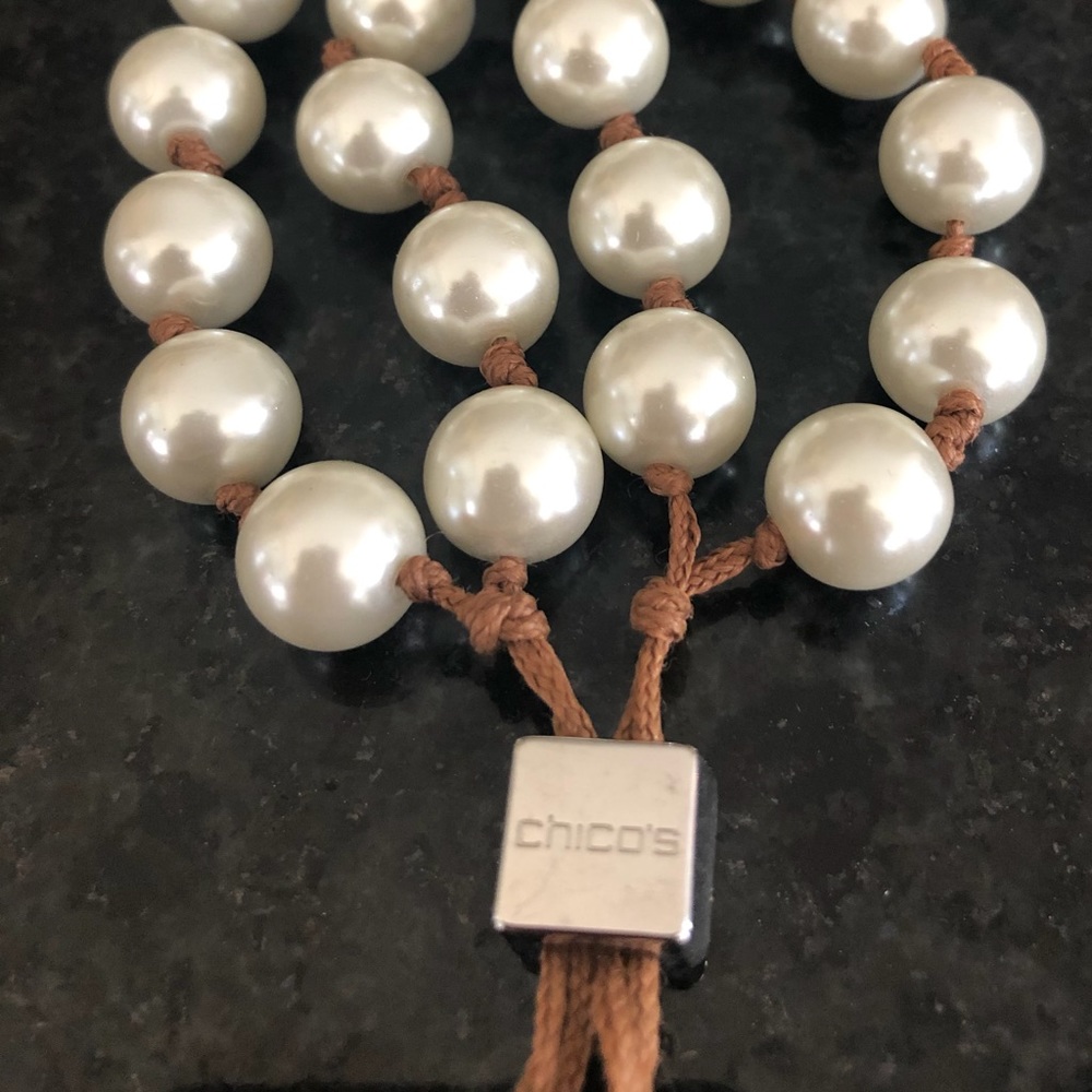 Chico’s adjustable pearl and leather tassel bracelet.